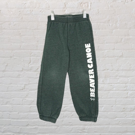 Dark green sweatpants with BEAVER CANOE text printed vertically on the leg.