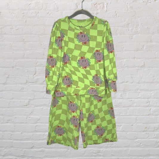 Green checkered pajama set with a colorful smiling flower print, featuring long sleeves and pants.