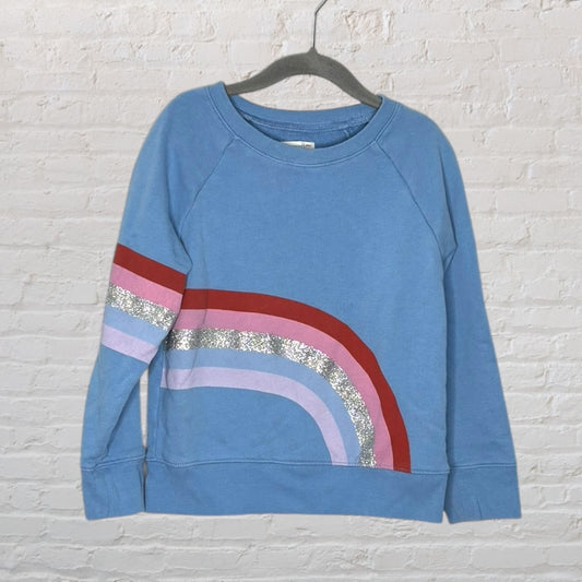 Blue sweatshirt with a rainbow graphic in red, pink, silver, and purple stripes on the front.