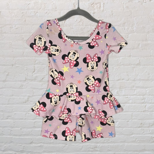 Pink peplum top and shorts set with Minnie Mouse and star print, displayed on a hanger.