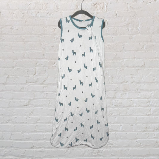 White baby sleep sack with teal llama prints and teal trim, hanging on a hanger.