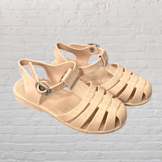 Beige rubber strappy sandals with buckle closure, featuring a matte finish.