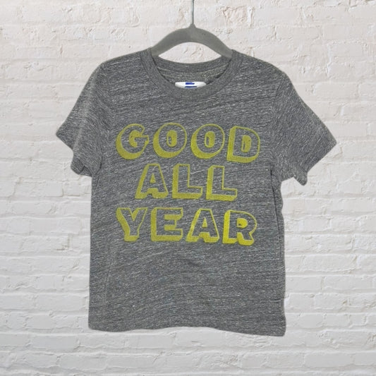 Heather grey short-sleeve T-shirt with 'Good All Year' printed in bold yellow letters, hanging on a hanger.