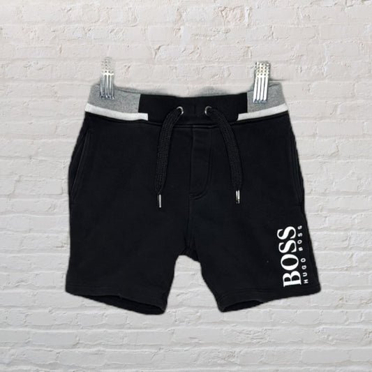 Men's black casual shorts with Hugo Boss logo, featuring a grey waistband and drawstring.